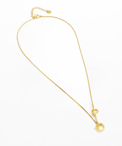 Gold necklace with a round pendant on a white background