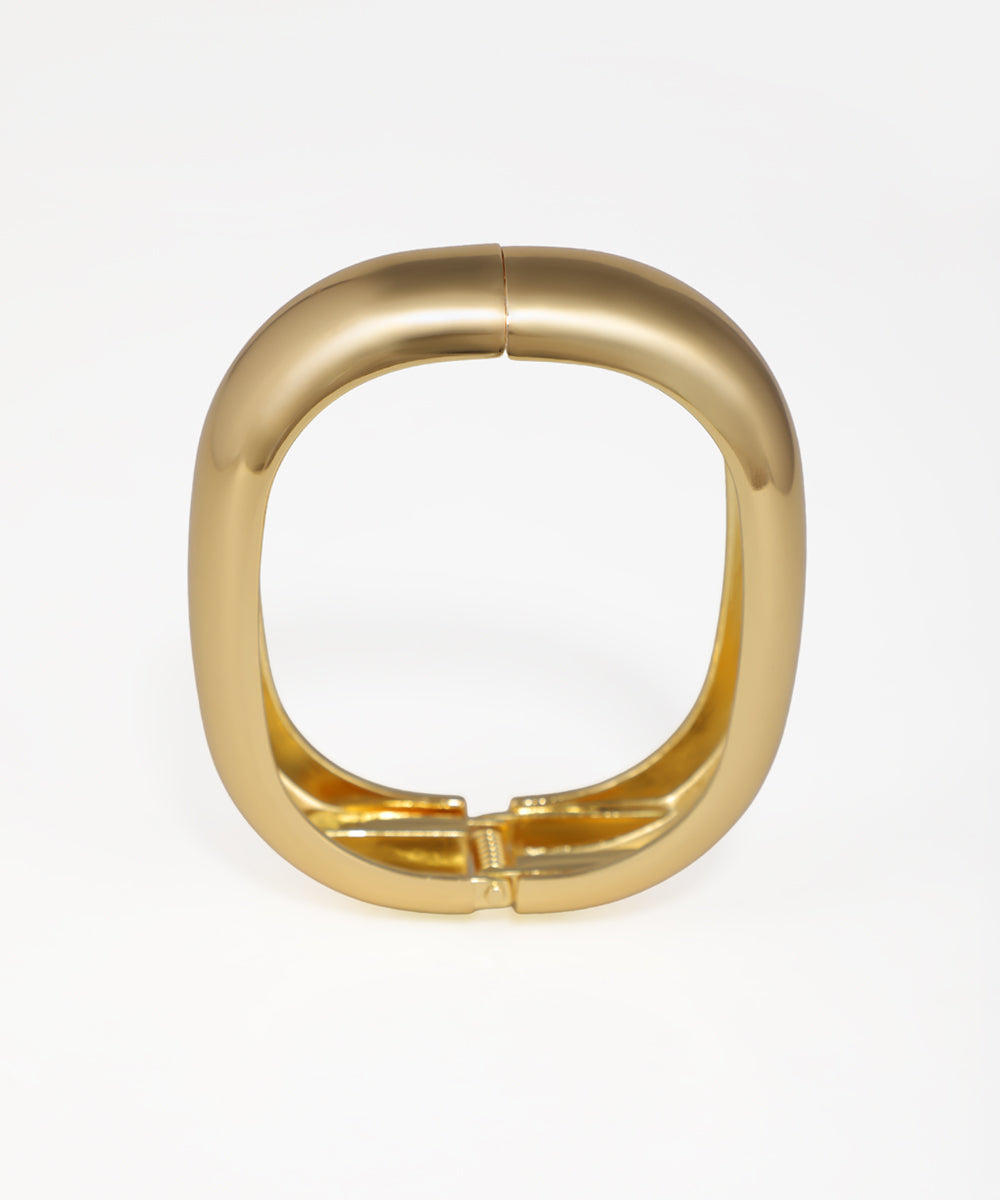 Gold ring with a unique design on a white background