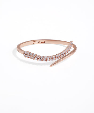 Rose gold bracelet with clear stones on a white background