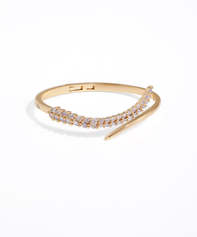 Gold bracelet with clear stones on a white background