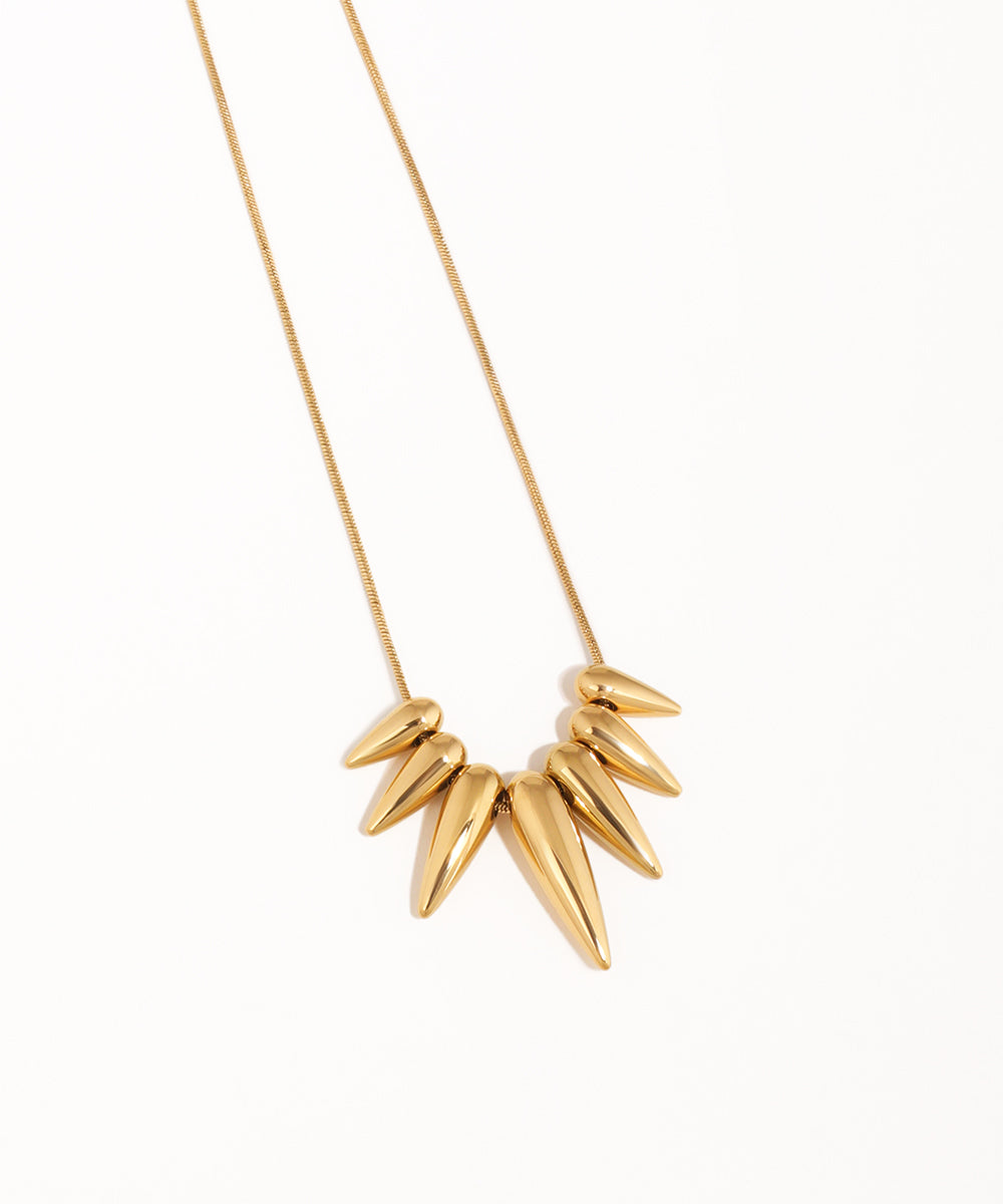 Gold necklace with leaf-like pendants on a white background