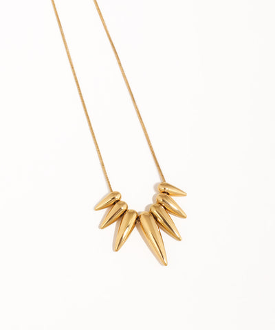 Gold necklace with leaf-like pendants on a white background
