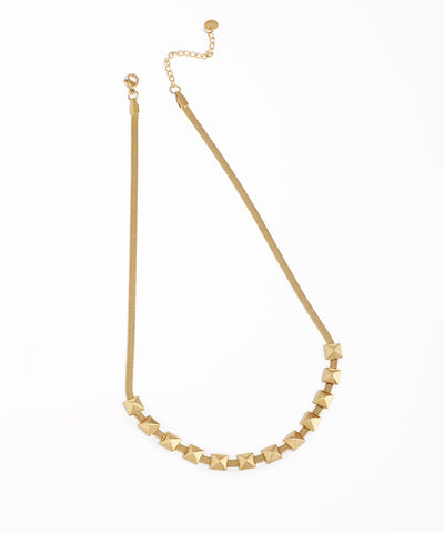 Gold-tone snake chain necklace with a front segment of pyramid studs