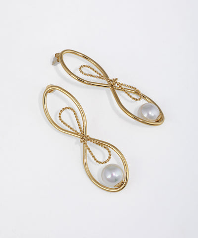 Gold-tone drop earrings with an elongated ribbon-like loop design and a large faux pearl