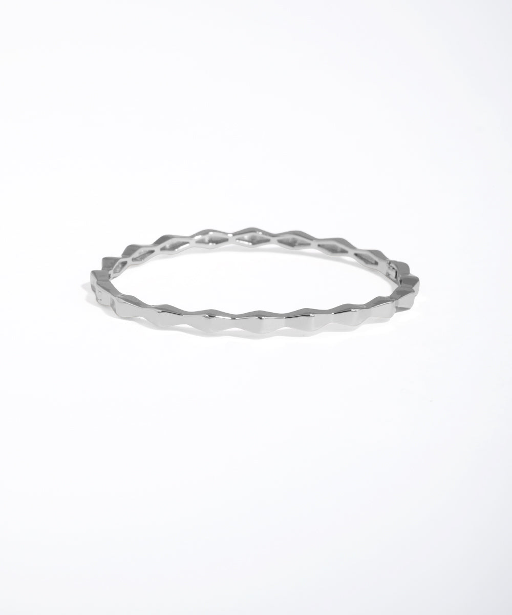 Silver ring with a textured design on a white background