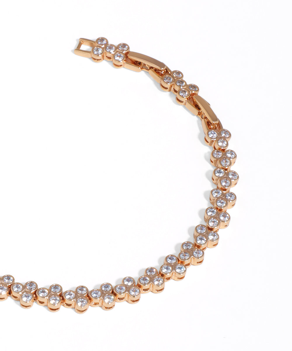 Rose gold bracelet with clear stones on a white background
