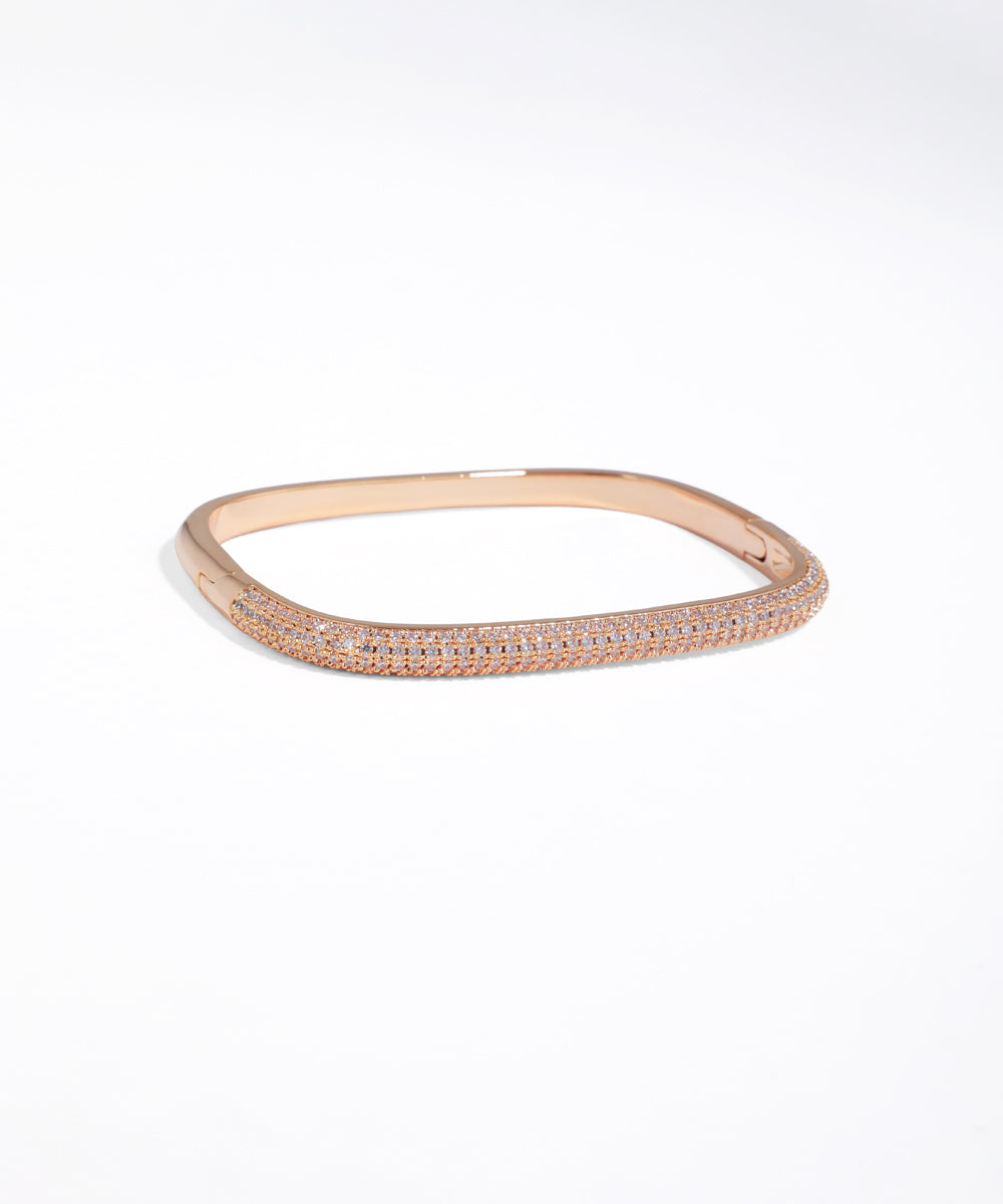 Rose gold bracelet with small diamonds on a white background