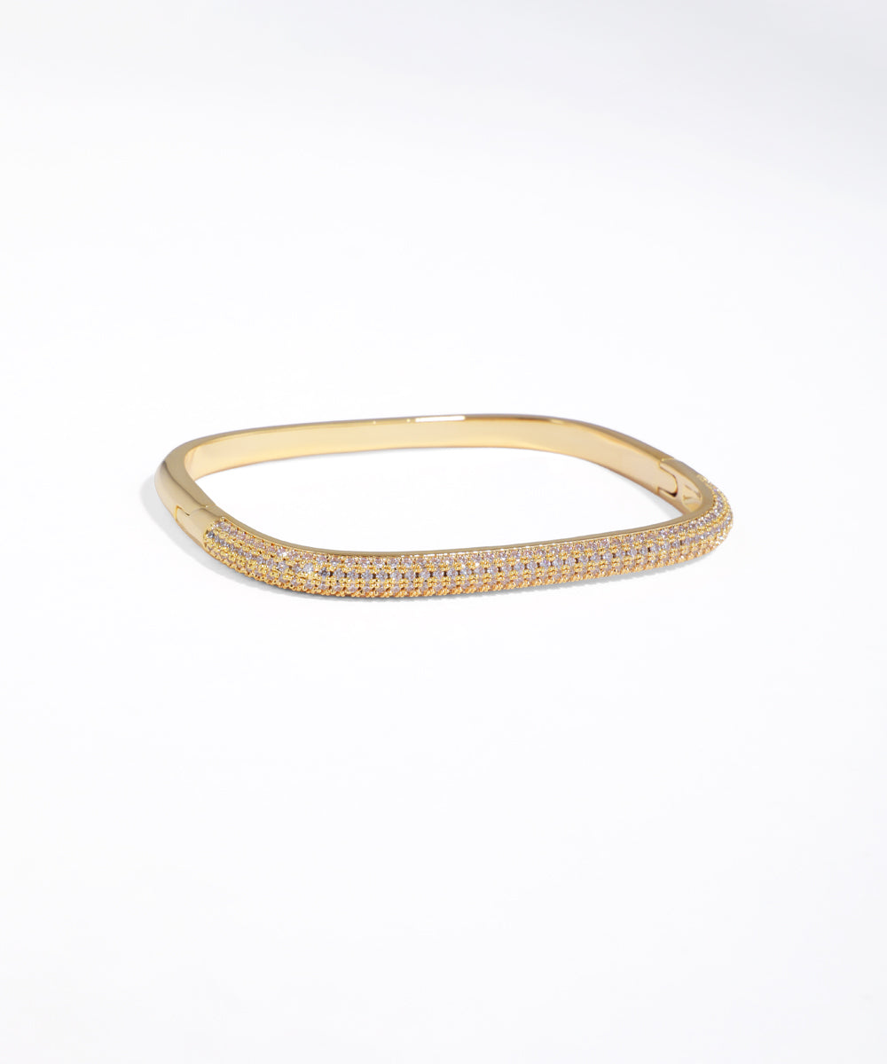 Gold bracelet with small stones on a white background