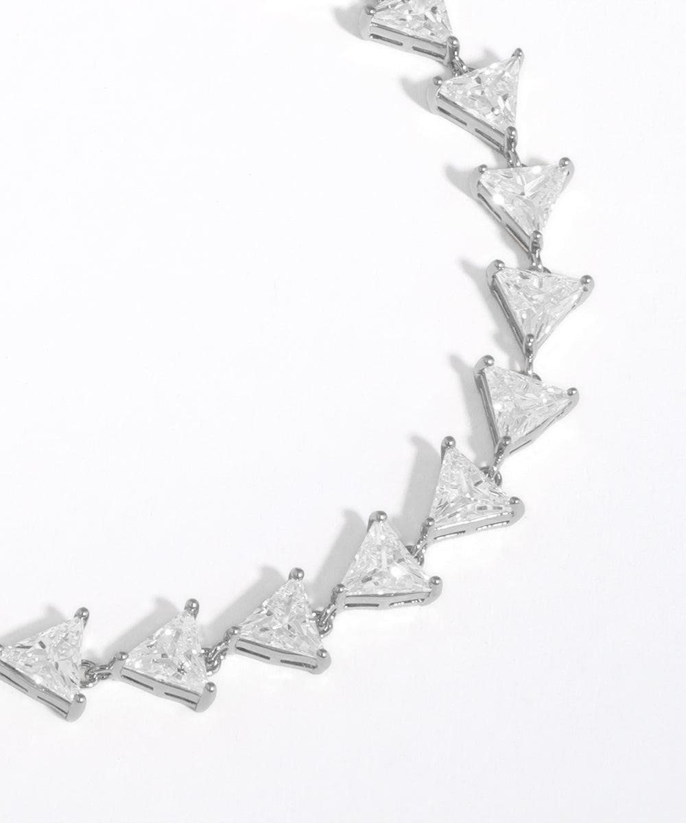 Silver bracelet with triangle-shaped diamonds on a white background