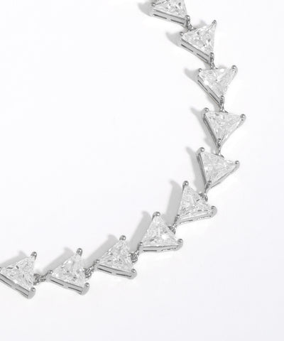 Silver bracelet with triangle-shaped diamonds on a white background