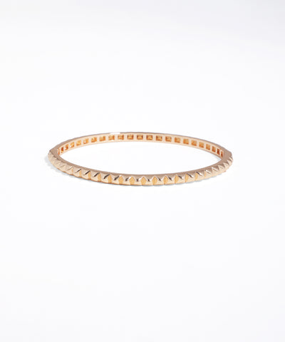 Rose gold bangle on a white background