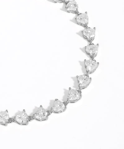 Silver bracelet with teardrop-shaped crystals on a white background
