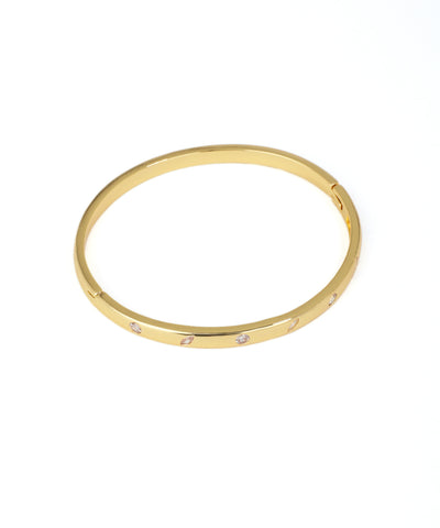 Gold bracelet with small diamonds on a white background
