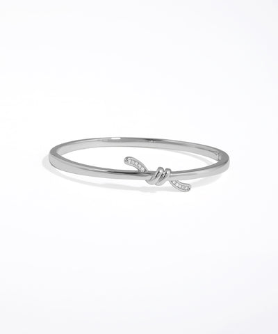 Silver bracelet with a knot design on a white background