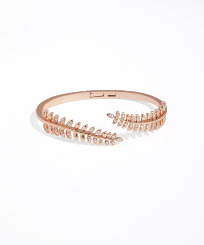 Rose gold bracelet with leaf-like design on a white background