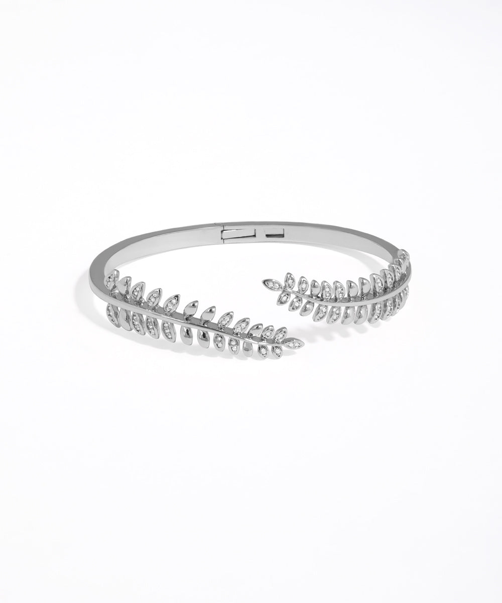 Silver bracelet with clear stones on a white background