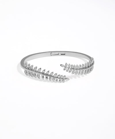 Silver bracelet with clear stones on a white background