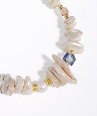 Necklace with pearls and gold accents on a white background