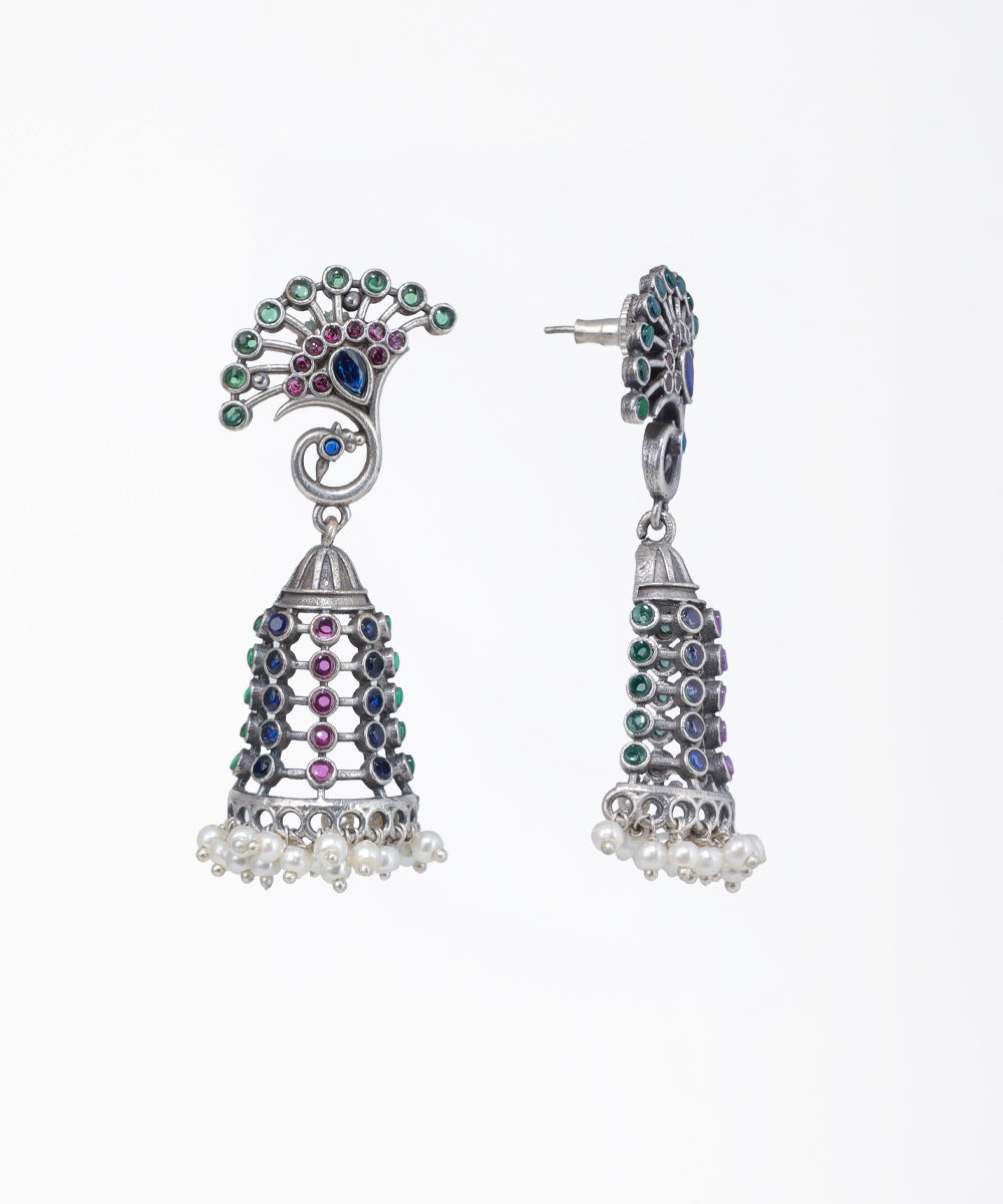 Decorative earrings with colorful gemstones on a white background