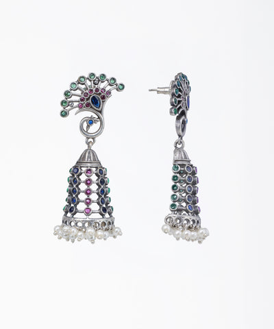 Decorative earrings with colorful gemstones on a white background