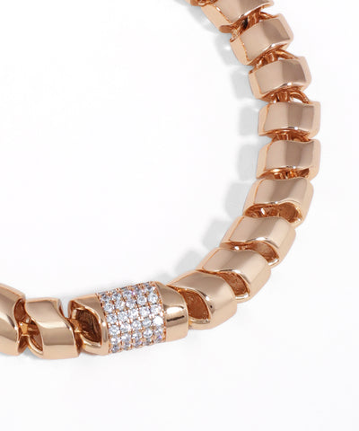 Rose gold chain bracelet with a diamond-studded clasp on a white background