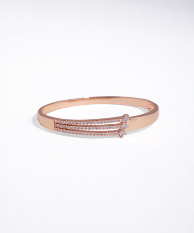 Rose gold bracelet with clear stones on a white background