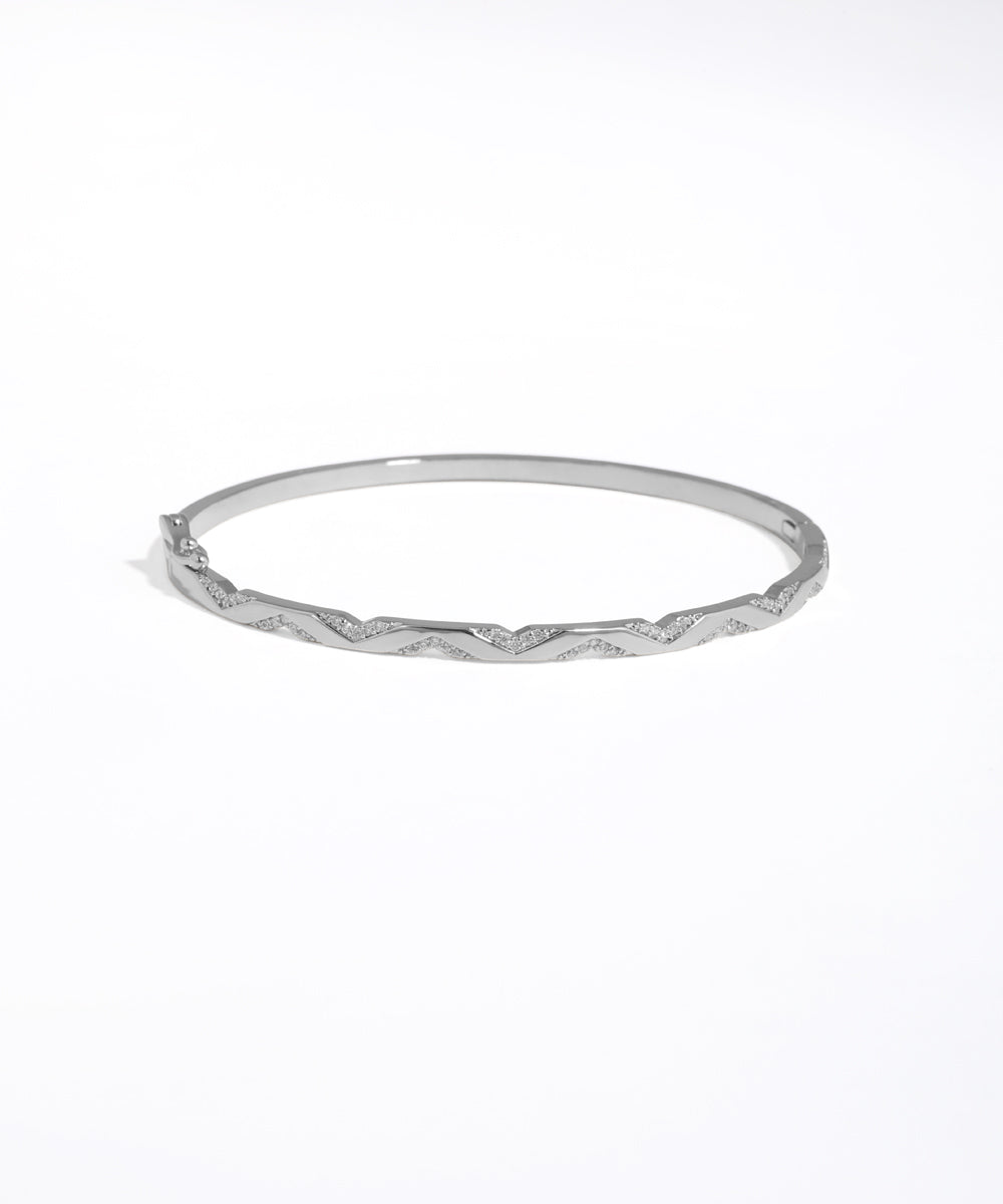 Silver bangle on a white background