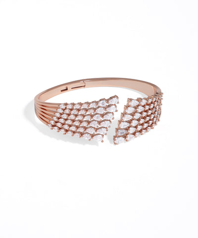 Rose gold bracelet with clear gemstones on a white background