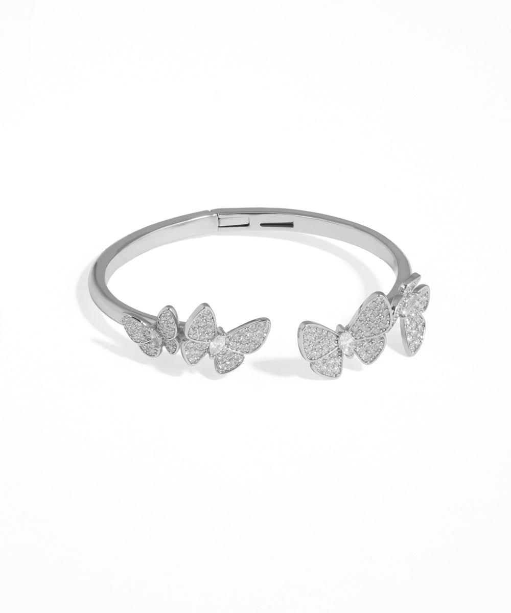 Silver bracelet with butterfly designs on a white background