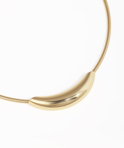 Gold necklace with a curved pendant on a white background