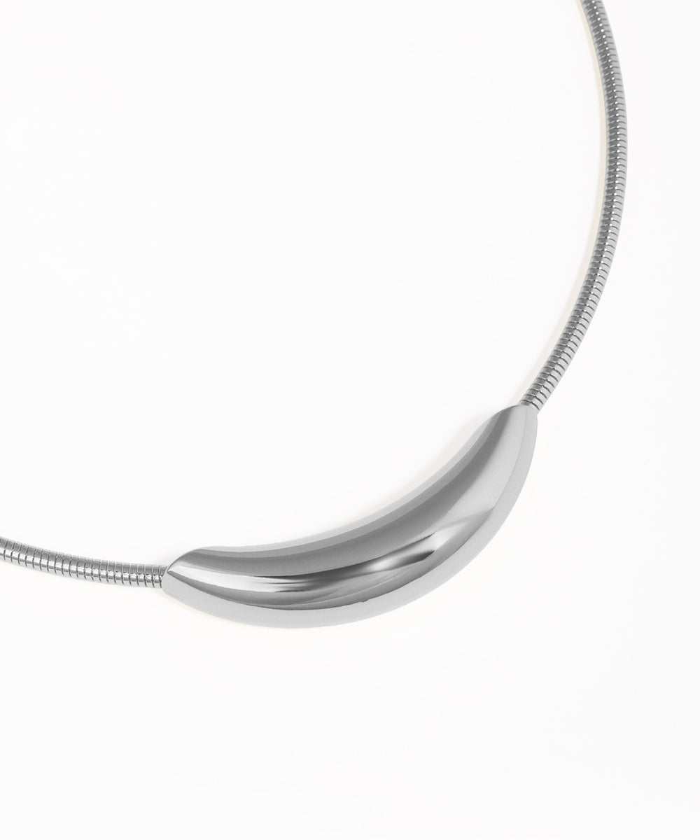 Silver necklace with a curved pendant on a white background