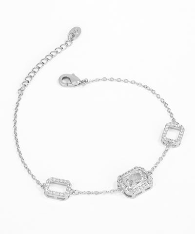 Silver bracelet with square-shaped crystals on a white background