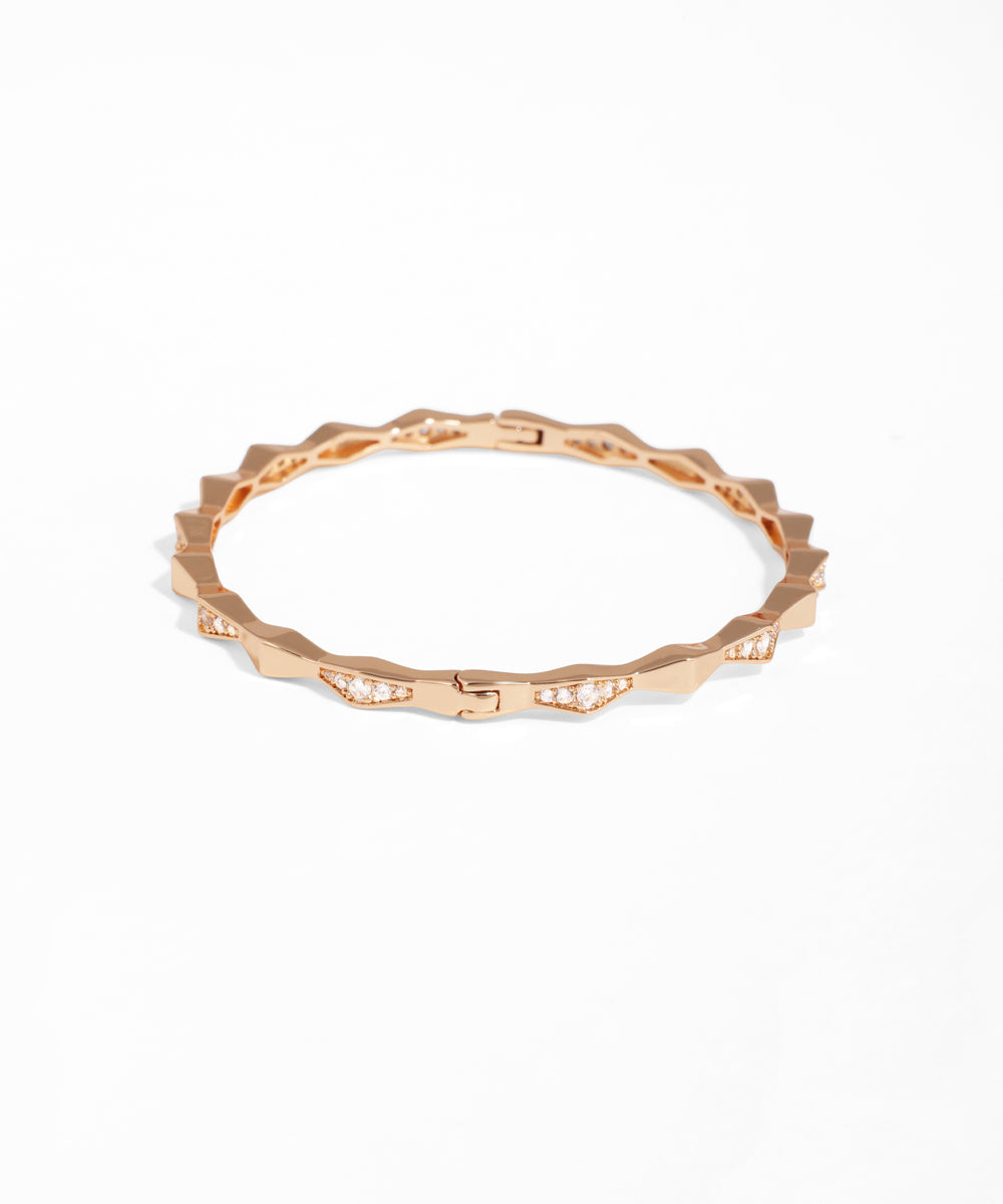 Rose gold ring with a textured band on a white background