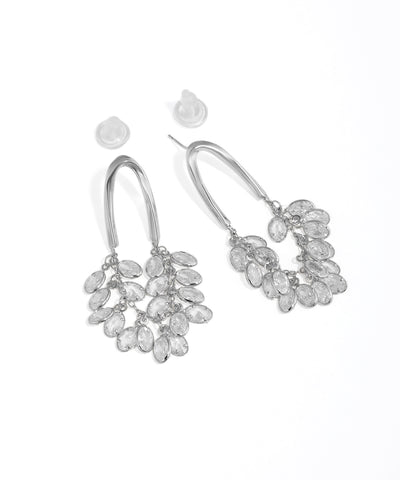 Silver earrings with clear stones on a white background