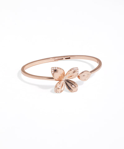 Rose gold bracelet with butterfly charms on a white background
