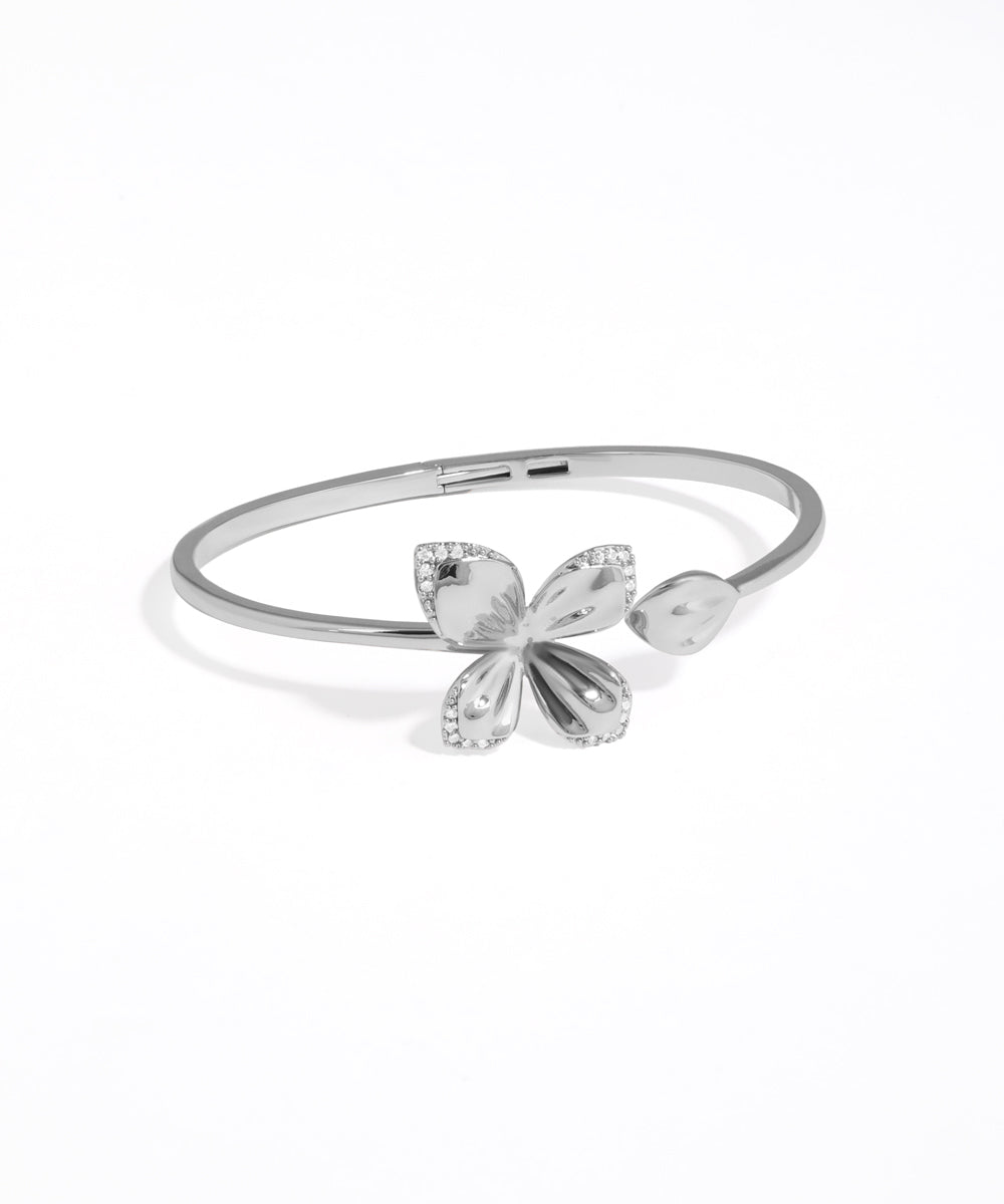 Silver bracelet with butterfly design on a white background