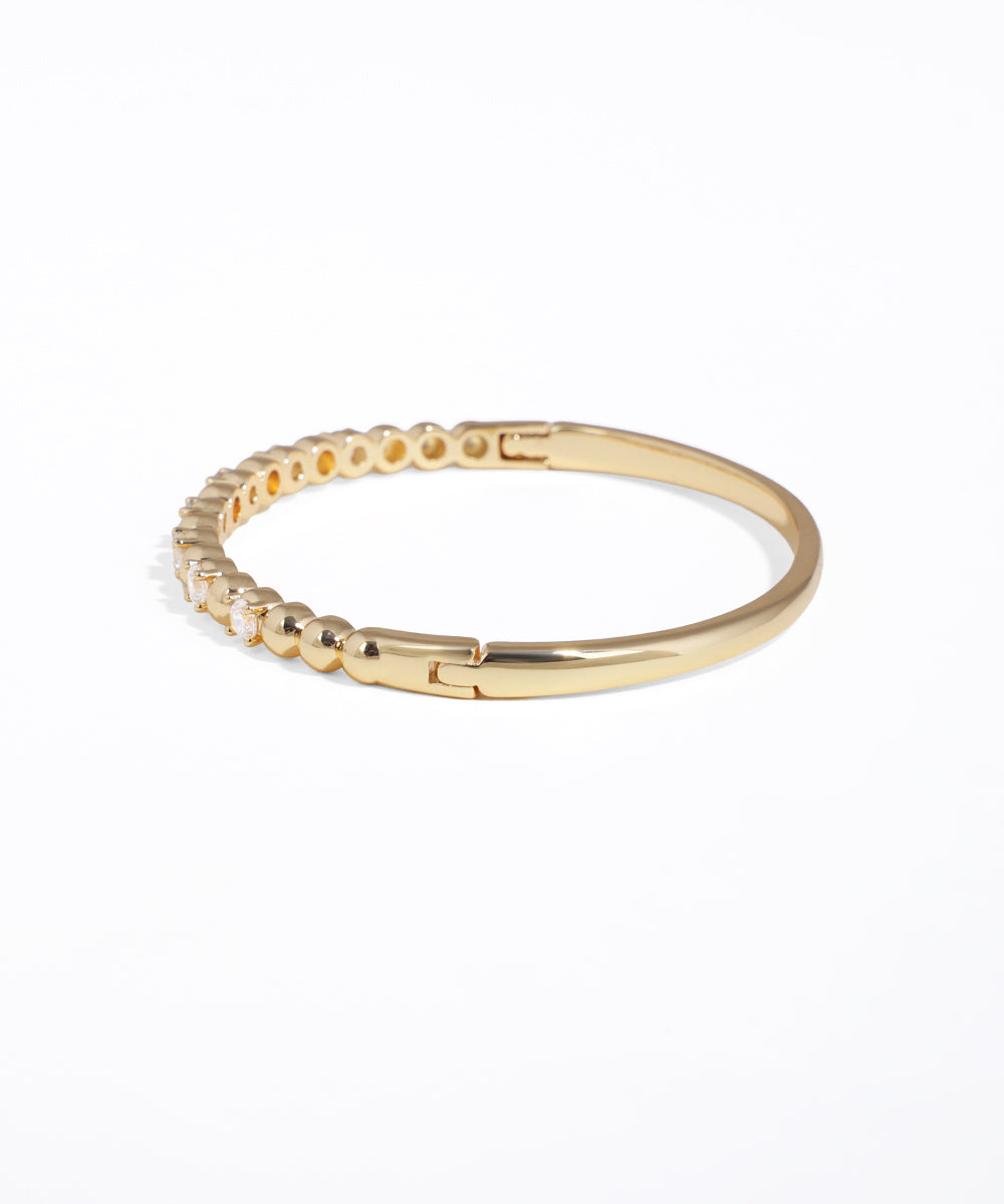 Gold bracelet on a white background