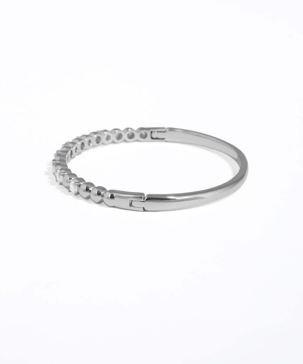 Silver ring with small stones on a white background
