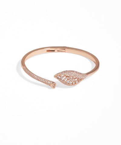 Rose gold bracelet with leaf design on a white background