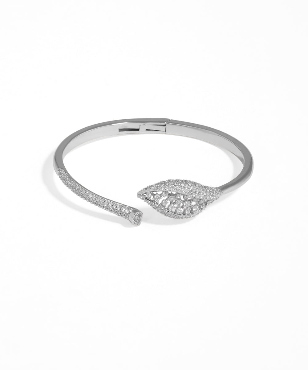 Silver bracelet with leaf design on a white background