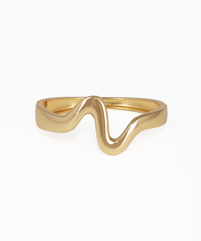 Gold ring with a wavy design on a white background