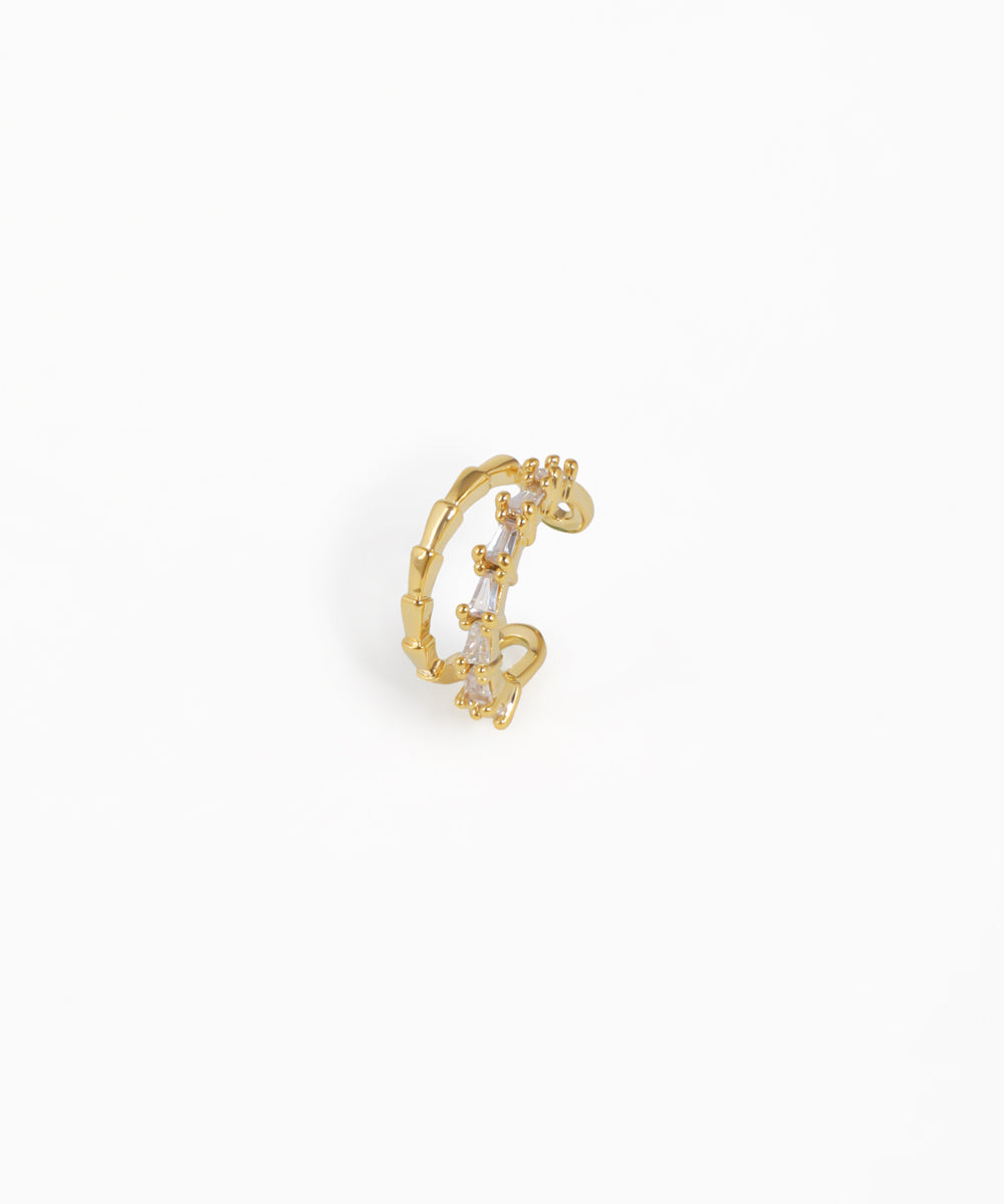 Gold-tone ear cuff with baguette and round cubic zirconia stones and textured band
