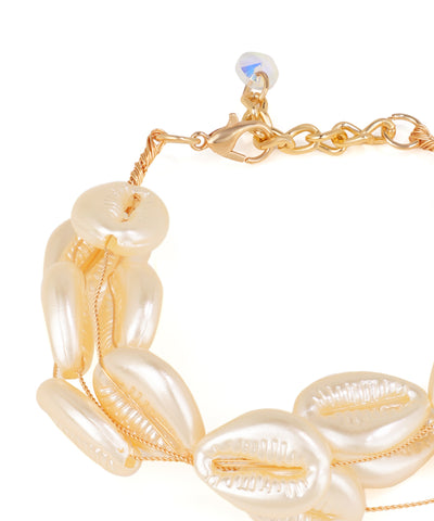 Gold and pearl bracelet on a white background