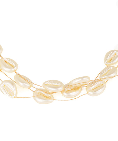 Gold necklace with shell-like beads on a white background