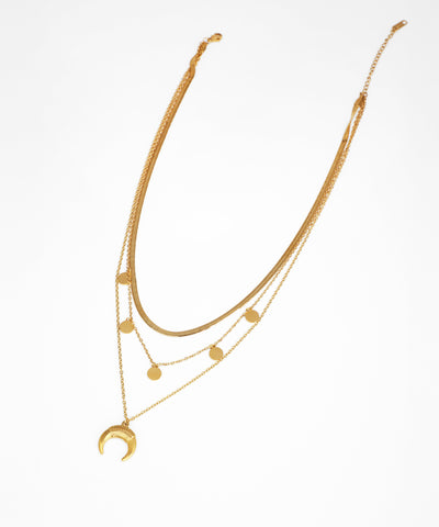 Gold necklace with multiple layers and a crescent moon pendant on a white background