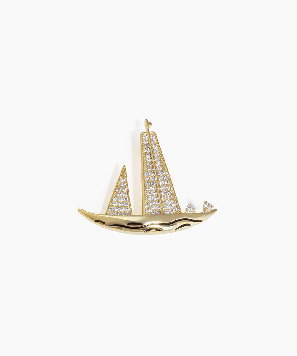 Gold-tone brooch with sailboat design and clear cubic zirconia stones