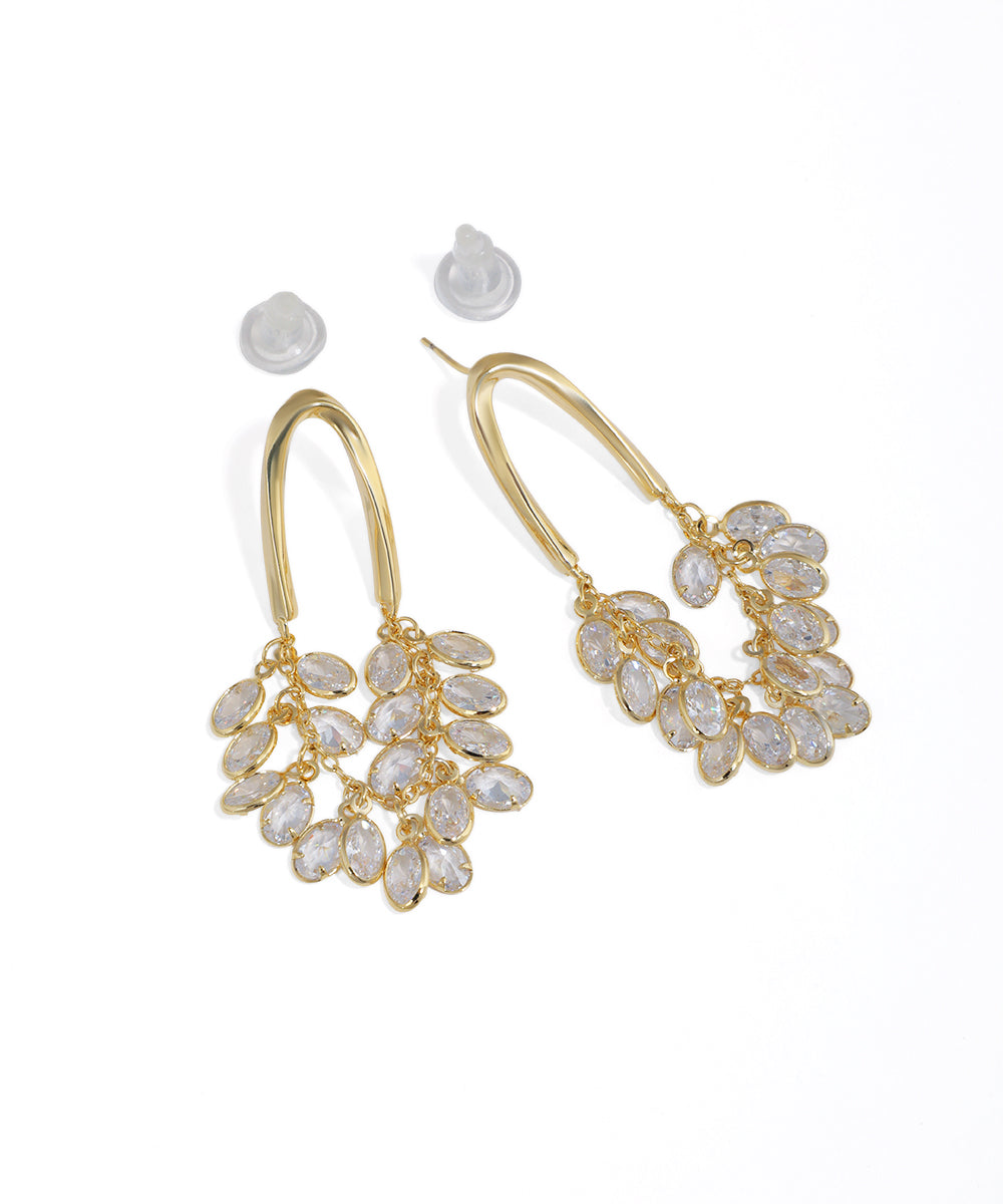 Gold-tone drop earrings with a curved arch and sparkling clear cubic zirconia cluster.