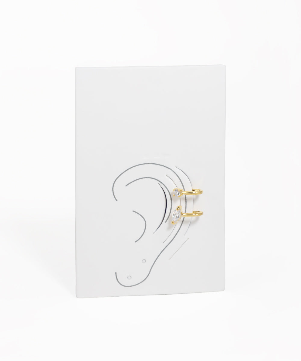 Earring display card with ear illustration and gold earrings on a white background