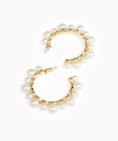 Gold-tone earrings with faux pearls in a curved half hoop design