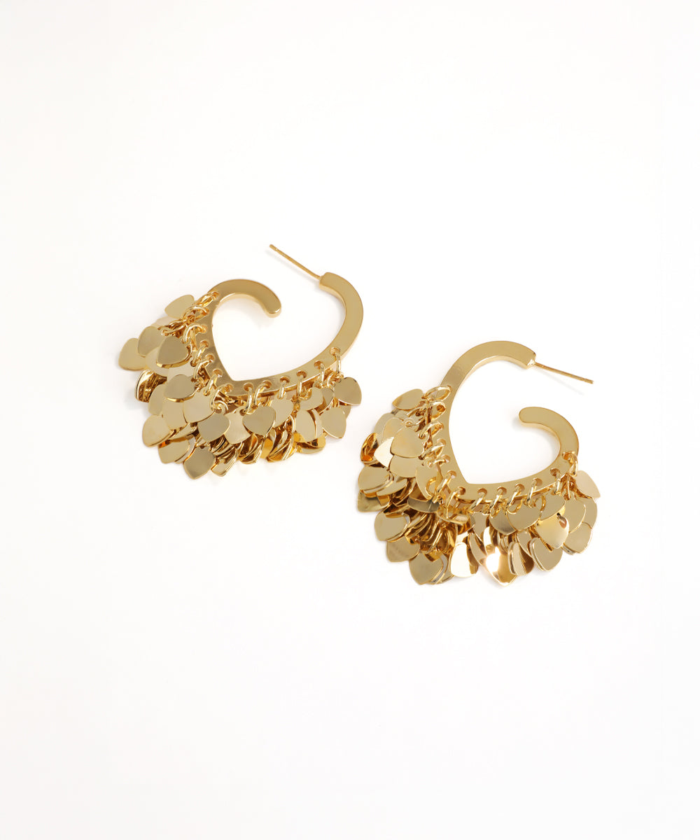 Gold hoop earrings with a textured design on a white background